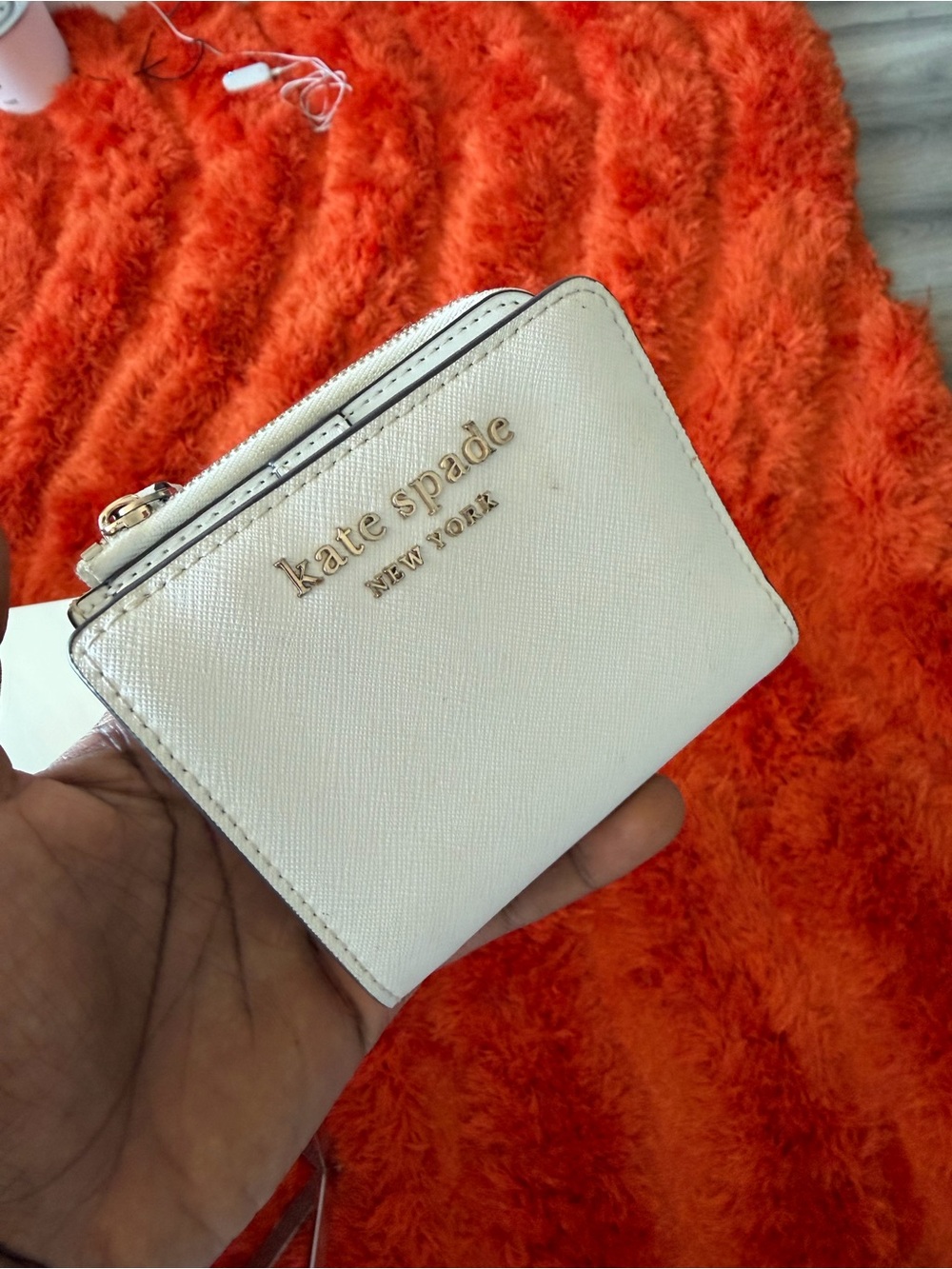 kate spade cream saffiano zip-around wallet with gold logo
